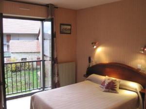 Postel nebo postele na pokoji v ubytování L'Auberge Campagnarde