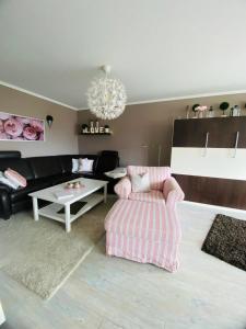 a living room with a couch and a chair at Seeschloss Wohnung 22 in Dahme