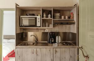 a kitchen with a sink and a microwave at 3BD Apartment in the Center - Self check in in Patra
