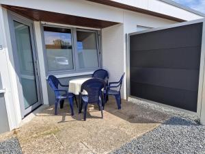 a patio with a table and chairs on a house at Feriengarten Dahme W 8 in Dahme