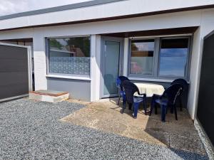 a patio with a table and chairs on the side of a house at Feriengarten Dahme W 8 in Dahme +3 photos