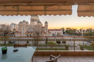 a view of a building from the balcony of a restaurant at 3BD Apartment in the Center - Self check in in Patra
