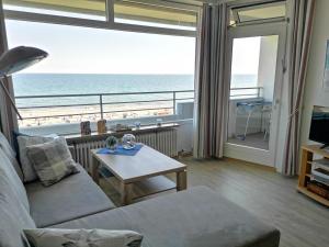 a living room with a view of the ocean at Strandhotel Wohnung 61 in Dahme