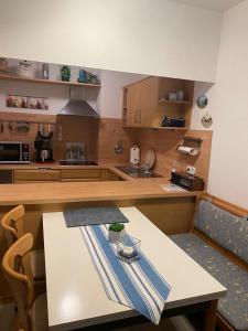 a kitchen with a table and a counter top at Strandhotel Wohnung 61 in Dahme +7 photos