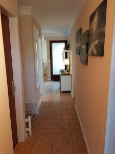 a hallway with a tiled floor and a doorway at Feriengarten Dahme W 13 in Dahme +1 photo
