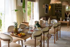 a dining room with a wooden table and chairs at Smala Beldi Guest House in Essaouira