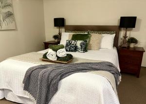 a bedroom with a bed with two towels on it at Jacaranda House Garden Suite in Brisbane