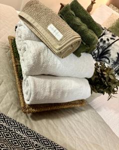a pile of towels sitting on top of a bed at Jacaranda House Garden Suite in Brisbane +43 photos