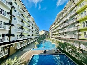 an apartment building with a pool in the middle at Amani Airport Haven - 726 in Pusok