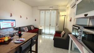 a living room with a couch and a table and a tv at Sweetheart Apartment in Busto Arsizio +32 photos