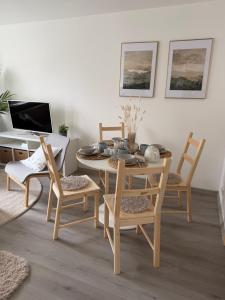 a dining room with a table and chairs and a desk at Apartmány Loučky Litvínov in Litvínov