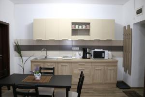 Corso Comfort Apartments في سيبيو: مطبخ مع طاولة وميكروويف