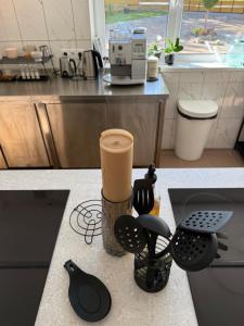 a kitchen counter with utensils and a coffee maker at visitDINAMO in Kandava +178 photos