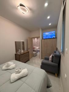 a bedroom with a large bed with two towels at Aggelos Room 1 in Volos
