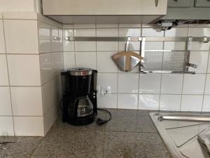 a coffee maker in a corner of a kitchen at Ferienwohnung Detmold Diestelbruch in Detmold +44 photos