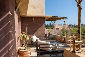 a patio with two chairs and a table at Smala Beldi Guest House in Essaouira