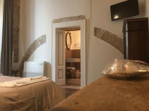 Postel nebo postele na pokoji v ubytování Palazzo Lupicini Affittacamere