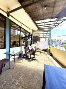 a room with a table and a gym on a building at Isla Boracay Inn in Boracay