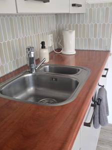 a kitchen counter with a stainless steel sink at Hooisma's Erf in Kampen +23 photos