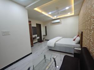 a hotel room with a bed and a bathroom at Hotel Jms Inn in Agra +39 photos