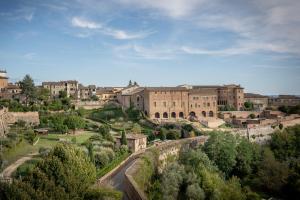a view of a city with buildings and trees at Hotel Athena in Siena