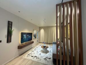a hallway with a television and a living room at shunshig 11 in Ulaanbaatar