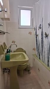 a bathroom with a sink and a toilet and a window at DaMa Blue in Saronida +18 photos