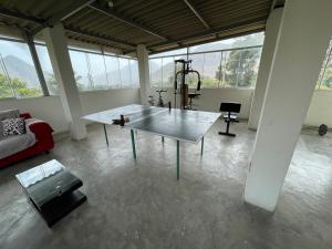 a living room with a table in a room with windows at El Sol de Simbal in Trujillo