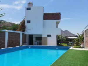 a swimming pool in front of a villa at El Sol de Simbal in Trujillo