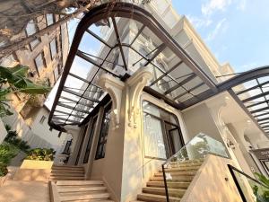 a house with a glass roof and stairs at Osea Hotel in Sihanoukville