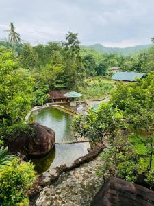 a river with a house in the middle of a forest at Hasruk Eco Rest in Yatipauwa