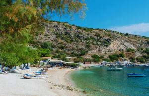a beach with a bunch of boats in the water at The Yiameli Collection - Levandi in Zakynthos +26 photos