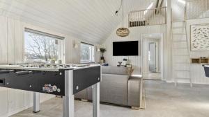 a kitchen with a stove top in a living room at Villavilla 182 - Rømø, Sydjylland in Høm