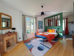 a bedroom with a bed and a fireplace at Maison Coquelin - Adults Only in La Roche-Guyon