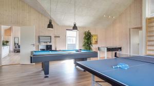 a living room with two ping pong tables in it at Villavilla 451 - Grenå Strand, Østjylland in Grenå