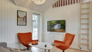 a living room with two chairs and a table at Villavilla 386 - Ebeltoft, Østjylland in Ebeltoft
