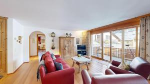 a living room with a couch and a table at Apartment Macun in Silvaplana