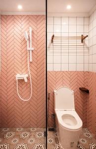 a bathroom with a toilet and a shower at R4R RoomforRest Boutique Hotel Bangsaen Beach in Ban Laem Thaen