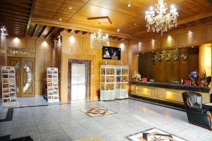 a large room with a store with a chandelier at Taj Palace Hotel & Spa in Dushanbe