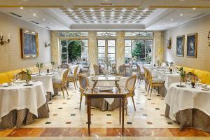 a restaurant with tables and chairs in a room at Relais & Châteaux Hotel Orfila in Madrid
