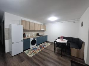 a kitchen with a table and a white refrigerator at Park Residence in Hoghiz +10 photos