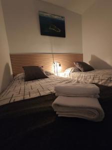 two beds in a hotel room with towels on them at The New House in Tabernas