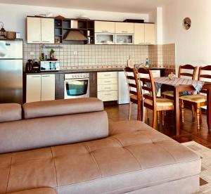 a kitchen with a couch and a table with chairs at Villa Vistamar Lapcici in Budva