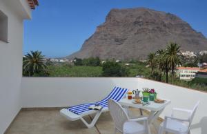 a balcony with a table and chairs and a mountain at Casa Antonio in Valle Gran Rey