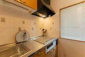a kitchen with a sink and a mirror and a window at Shirarutoro Villa in Shibecha +36 photos