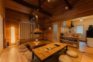 a living room with wooden walls and a wooden table at Shirarutoro Villa in Shibecha