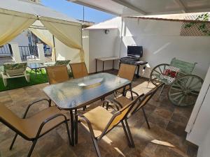a table and chairs in a room with a patio at CitySun in Málaga