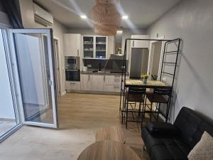 a living room with a kitchen with a table and chairs at CitySun in Málaga +13 photos