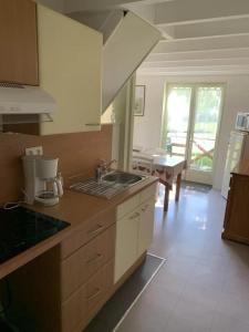 a kitchen with a sink and a counter top at ZEcamping 3 étoiles piscine animaux acceptés in Montaut