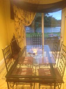 a glass table and chairs in a room at B&B on Ballyneety Golf Course in Limerick